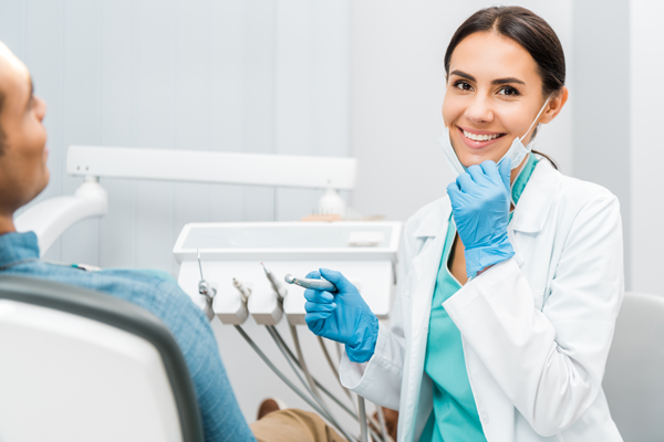 Smiling woman with patient at dental clinic